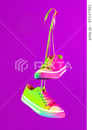 Modern sports shoes over neoned background. Sneakers or trainers isolated. Athletic shoes. fitness, sport, training concept. Urban fashion 92547901