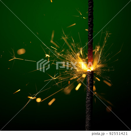 burning sparkler on green 92551421