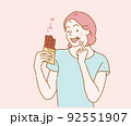 Young woman eating chocolate bar. Hand drawn in thin line style, vector illustrations. 92551907