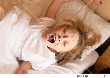 Yawns mobile phone sleep girl young beautiful bed eyes morning, for white caucasian in person for calm bedding, bedtime healthy. Indoors serene cozy, Yawns mobile phone sleep girl young beautiful bed eyes morning, for white caucasian in person for calm bedding, bedtime healthy. Indoors serene cozy, 92553019