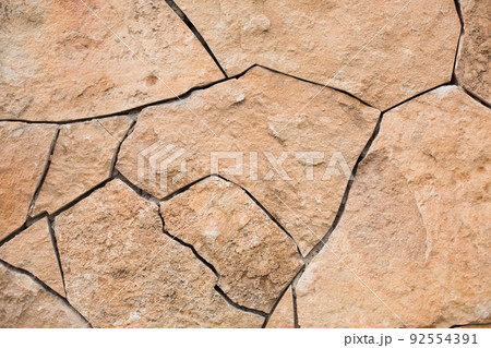 Masonry walls of natural sand color. Stone texture close-up, construction and mining background. 92554391