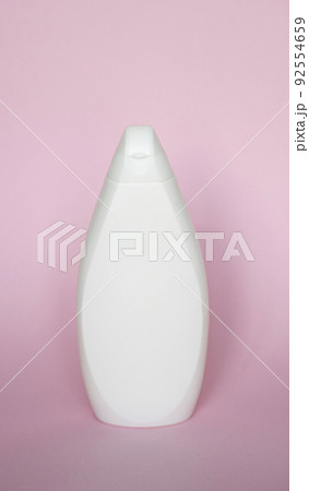 White plastic soap shampoo bottle isolated on pink background. Skin care lotion. Bathing essential product. Shampoo bottle. Bath and body lotion. Fine liquid hand wash. Bathroom accessories. White plastic soap shampoo bottle isolated on pink background. Skin care lotion. Bathing essential product. Shampoo bottle. Bath and body lotion. Fine liquid hand wash. Bathroom accessories. 92554659