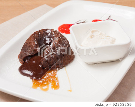 chocolate fondant with ice cream, caramel and berry sauce chocolate fondant with ice cream, caramel and berry sauce 92555259
