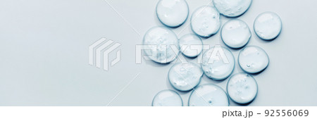 Liquid gel abstract cosmetic swatch drops on blue banner. Smear of transparent moisturizing product 92556069