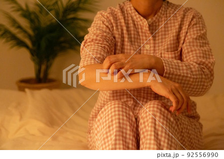 パジャマ姿でかゆみに苦しむミドル女性 パジャマ姿でかゆみに苦しむミドル女性 92556990