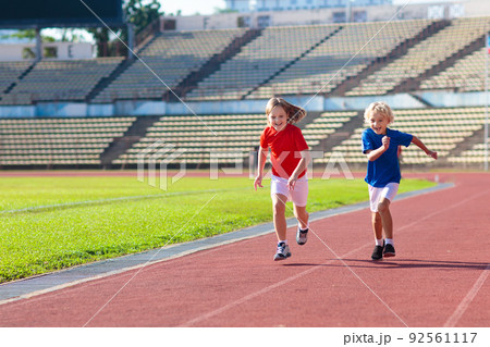 Child running in stadium. Kids run. Healthy sport. Child running in stadium. Kids run. Healthy sport. 92561117