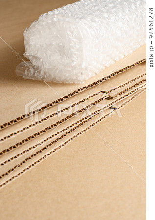 Cardboard, open boxes and bubble wrap. The concept of careful packaging of parcels. Copy space. 92561278