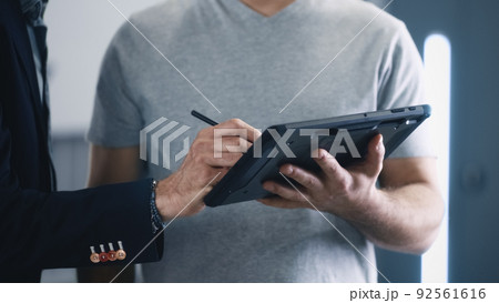 Male client accepting car diagnostics Male client accepting car diagnostics 92561616