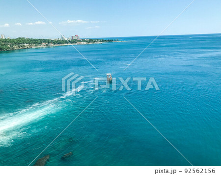 a yacht with tourists floats on the sea with white foam. yacht with people on the high seas. travel in a tropical country. seaside resort a yacht with tourists floats on the sea with white foam. yacht with people on the high seas. travel in a tropical country. seaside resort 92562156
