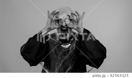 Joyful man with bloody scars face, Halloween zombie showing golden bitcoins mining future technology 92563325