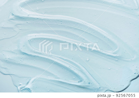 Liquid gel abstract cosmetic blue background. Smear of transparent moisturizing product 92567055