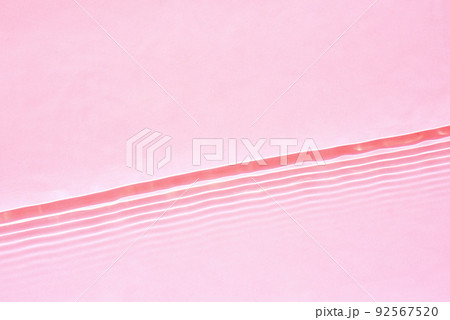 Transparent pink water surface texture with horizontal waves and ripples Transparent pink water surface texture with horizontal waves and ripples 92567520