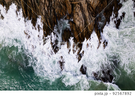 Aerial view Top down seashore big wave crashing on rock cliff Beautiful dark sea surface in sunny day summer background Amazing seascape top view seacoast at Phuket Thailand Aerial view Top down seashore big wave crashing on rock cliff Beautiful dark sea surface in sunny day summer background Amazing seascape top view seacoast at Phuket Thailand 92567892