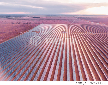 Aerial top view of a solar panels power plant. Photovoltaic solar panels at sunrise and sunset in countryside from above. Modern technology, climate care, earth saving, renewable energy concept. Aerial top view of a solar panels power plant. Photovoltaic solar panels at sunrise and sunset in countryside from above. Modern technology, climate care, earth saving, renewable energy concept. 92571196
