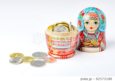Traditional Russian toy matryoshka and money. White background. Copy space 92573186