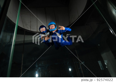 A man teaches a boy to fly in a wind tunnel. Lack of gravity. A man teaches a boy to fly in a wind tunnel. Lack of gravity. 92574022