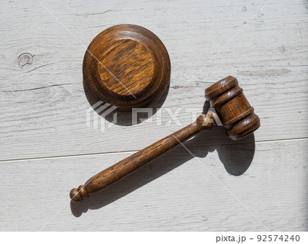 Wooden judicial gavel on a wooden laminate. 92574240