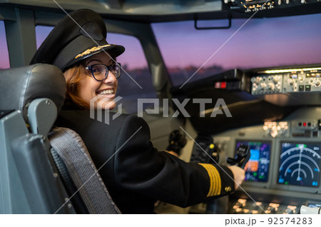 Female pilot on board the aircraft. Caucasian woman in flight simulator. 92574283