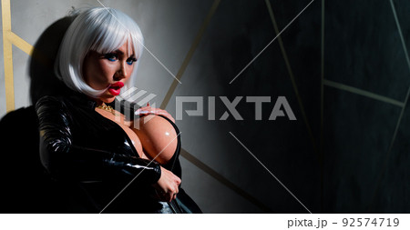 Sexy woman in a blonde wig and latex catsuit. Role-playing games 92574719