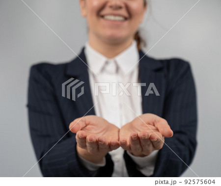 Close-up of caucasian woman holding her palms up.  92575604