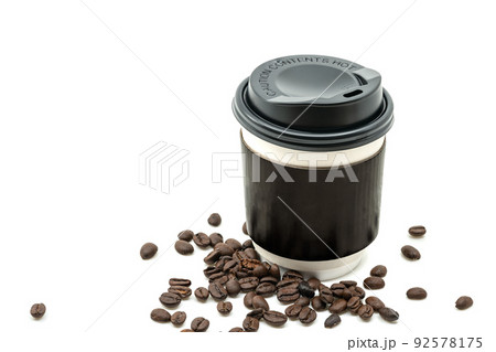 Takeaway a hot coffee cup with black cap and black cup paper holder, coffee beans is spread close to the cup. Empty space on the cup for design. Isolated on white background. 92578175