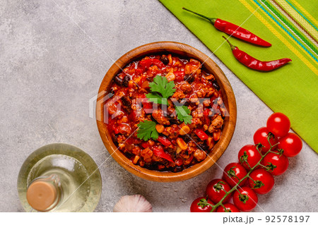 Chili Con Carne in bowl on grey background. Chili Con Carne in bowl on grey background. 92578197