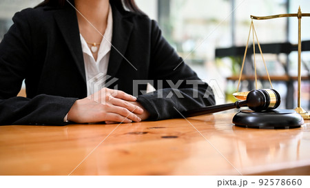 Successful and professional Asian female lawyer sits at her office desk. cropped Successful and professional Asian female lawyer sits at her office desk. cropped 92578660
