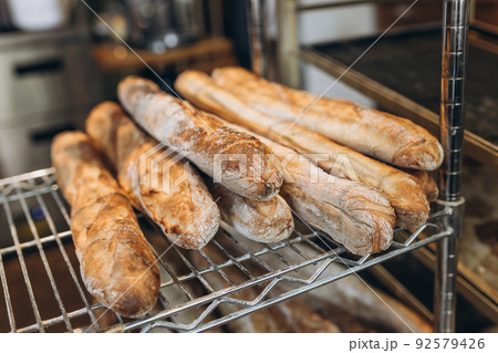 Fresh tasty Baguettes on bakery shelves. Concept of french delicious food Fresh tasty Baguettes on bakery shelves. Concept of french delicious food 92579426