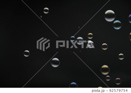 Flying soap bubbles on black background. Abstract soap bubbles with colorful reflections. Soap bubbles in motion background. Flying soap bubbles on black background. Abstract soap bubbles with colorful reflections. Soap bubbles in motion background. 92579754