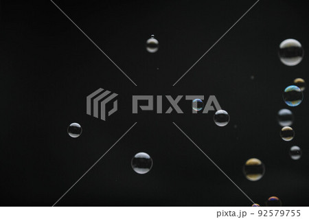 Flying soap bubbles on black background. Abstract soap bubbles with colorful reflections. Soap bubbles in motion background. Flying soap bubbles on black background. Abstract soap bubbles with colorful reflections. Soap bubbles in motion background. 92579755