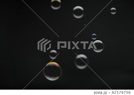 Flying soap bubbles on black background. Abstract soap bubbles with colorful reflections. Soap bubbles in motion background. Flying soap bubbles on black background. Abstract soap bubbles with colorful reflections. Soap bubbles in motion background. 92579756