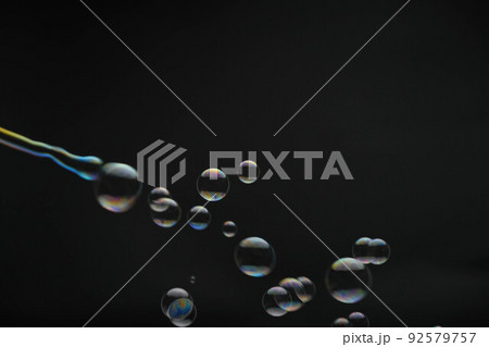Flying soap bubbles on black background. Abstract soap bubbles with colorful reflections. Soap bubbles in motion background. 92579757