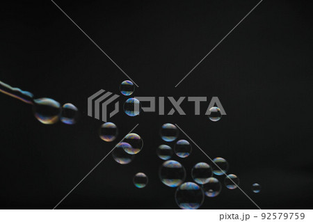 Flying soap bubbles on black background. Abstract soap bubbles with colorful reflections. Soap bubbles in motion background. Flying soap bubbles on black background. Abstract soap bubbles with colorful reflections. Soap bubbles in motion background. 92579759