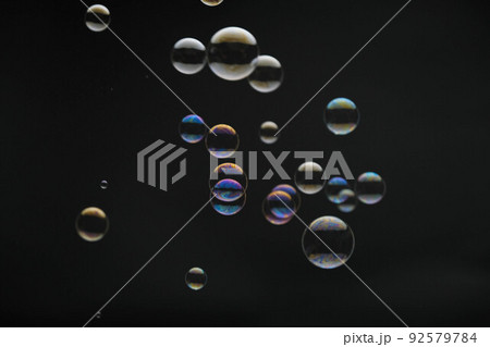 Flying soap bubbles on black background. Abstract soap bubbles with colorful reflections. Soap bubbles in motion background. Flying soap bubbles on black background. Abstract soap bubbles with colorful reflections. Soap bubbles in motion background. 92579784