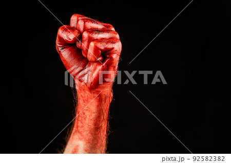 Bloody male fist on a black background. Copy space. Bloody male fist on a black background. Copy space. 92582382
