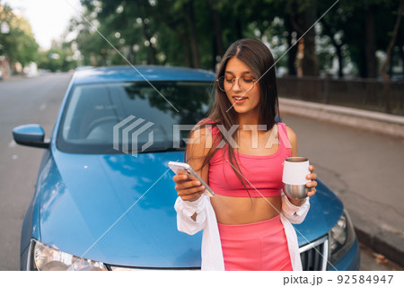 Woman drive car stop coffee break pause , use smartphone 92584947