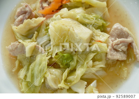 stir fried slice cabbage and pork with fish sauce on plate  92589007