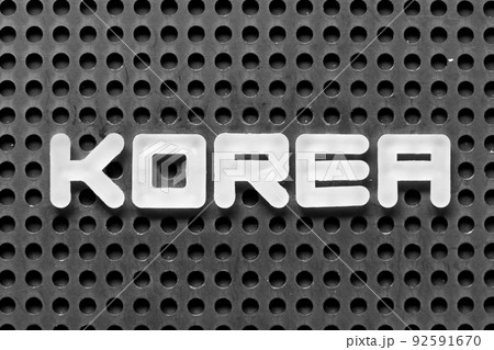 White alphabet letter in word korea on black pegboard background White alphabet letter in word korea on black pegboard background 92591670