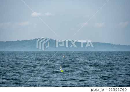 Lobster pot trap buoy floating on a choppy ocean in the Atlantic Ocean Lobster pot trap buoy floating on a choppy ocean in the Atlantic Ocean 92592760