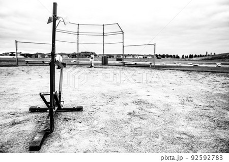 Mechanical youth slow pitching machine used to throw a baseball for batting Mechanical youth slow pitching machine used to throw a baseball for batting 92592783