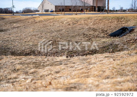 HDPE drainage culvert under a road entrance. Pipe is used to convey stormwater between ditches. 92592972