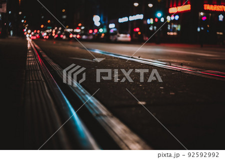 Street level selective focus on trolley rail lines at night in San Diego. 92592992
