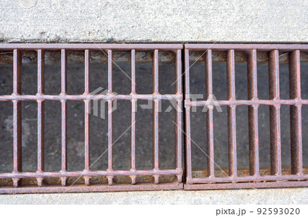Grate over a stormwater trench in a concrete slab. Grate over a stormwater trench in a concrete slab. 92593020