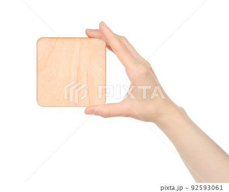 Hand holds blank wooden plaque on white background 92593061