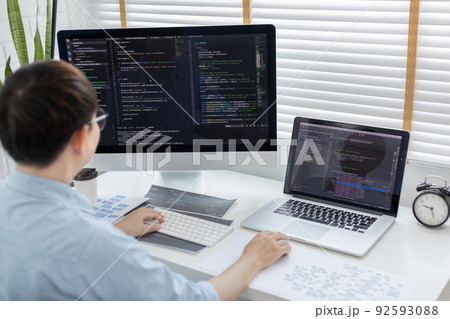 Professional development programmers are sit on a desk with work equipment such as: computer-laptop-tablet. for working in programming or writing code on  website,  HTML, javascript, Software. 92593088