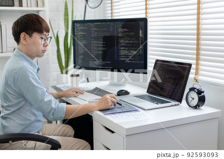 Professional development programmers are sit on a desk with work equipment such as: computer-laptop-tablet. for working in programming or writing code on website, HTML, javascript, Software. Professional development programmers are sit on a desk with work equipment such as: computer-laptop-tablet. for working in programming or writing code on website, HTML, javascript, Software. 92593093