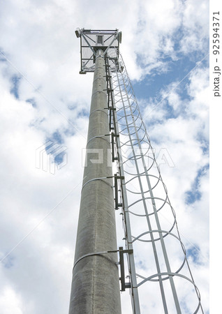 Cellphone tower with a blue sky background.Mobile operator's transceiver. Cellphone tower with a blue sky background.Mobile operator's transceiver. 92594371