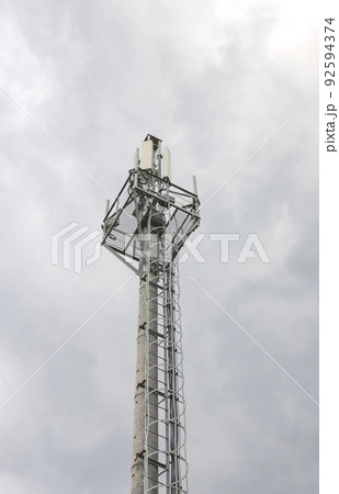 Cellphone tower with a blue sky background.Mobile operator's transceiver. Cellphone tower with a blue sky background.Mobile operator's transceiver. 92594374