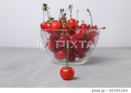 red cherry cherry close-up on the back background of a bowl of cherries. Seasonal berries vitamins benefitshed nutrition berries increase iron 92595264