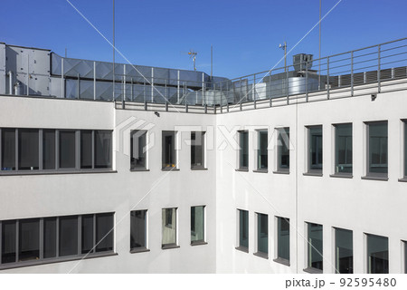 An office building with rooftop air conditioning system. 92595480